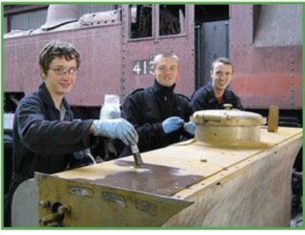 Engineering staff and volunteers working on mechanical and structural elements of the railway